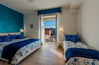 a bedroom with two beds and a balcony at Le vestali Guest House in Rome