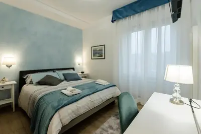 a bedroom with a bed and a table with a lamp at Le vestali Guest House in Rome