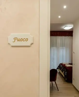 a sign on a wall in a room with a bedroom at Le vestali Guest House in Rome