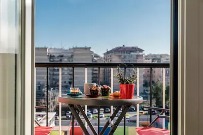 a table on a balcony with a view of a city at Le vestali Guest House in Rome