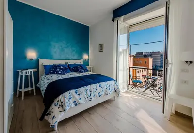 a bedroom with a bed and a large window at Le vestali Guest House in Rome