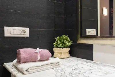 a bathroom with towels and a plant on a counter at 8 HOME in Rome