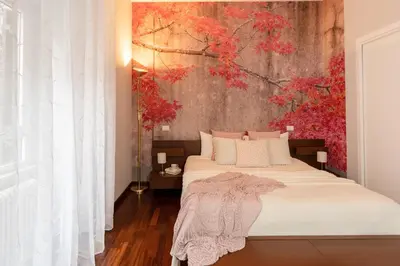 a bedroom with a bed with a painting on the wall at 8 HOME in Rome