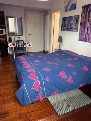 a bedroom with a blue bed with pink birds on it at BREAD & BUTTER in Rome