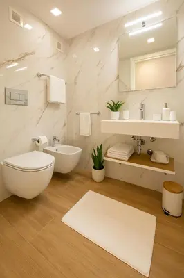 a white bathroom with a toilet and a sink at Spagna Lemon Suites in Rome