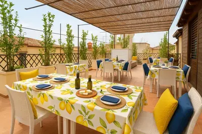 a patio with a table and chairs and a table and chairsktop at Spagna Lemon Suites in Rome