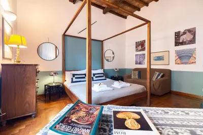 a bedroom with a four poster bed in a room at Appartamento via del Teatro Pace in Rome