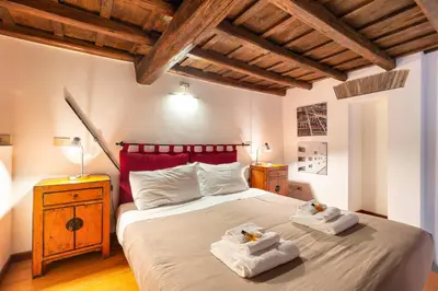 a bedroom with a large bed with towels on it at Appartamento via del Teatro Pace in Rome