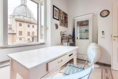 a kitchen with a white island and a window at Appartamento via del Teatro Pace in Rome