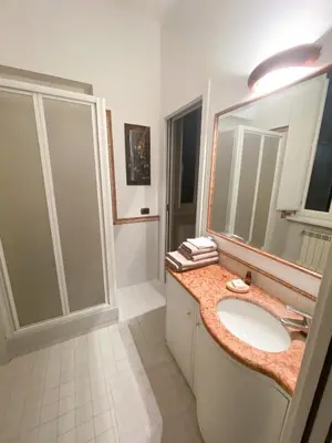 a bathroom with a sink and a shower and a mirror at OB1 Vacanze Romane in Rome