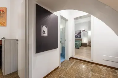 a hallway with an archway leading to a bedroom at Tour de Rome in Rome