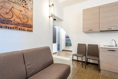 a living room with a couch and a kitchen at Tour de Rome in Rome