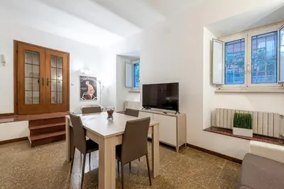 a dining room with a table and a television at Tour de Rome in Rome