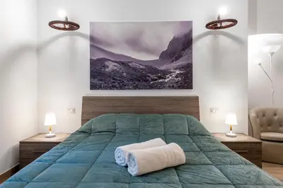 a bedroom with a green bed with two lamps at Tour de Rome in Rome