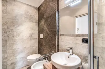 a bathroom with a sink and a toilet at Stasera a casa da M.E. in Rome