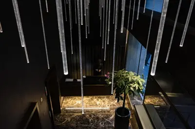 a person standing in a hallway with a potted plant at U-Visionary Roma Hotel in Rome