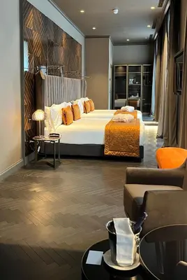 a hotel room with a bed and a couch at U-Visionary Roma Hotel in Rome