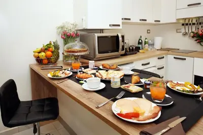 a kitchen counter with plates of food on it at La Maisonnette Tritone Trevi Apartment Rome in Rome