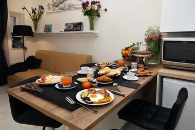 a breakfast table with breakfast foods on it at La Maisonnette Tritone Trevi Apartment Rome in Rome