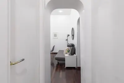 a door leading into a living room with a chair at iFlat Colosseum Comfy House in Rome