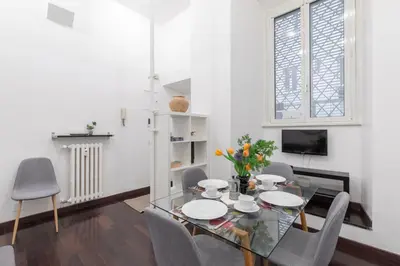 a dining room with a glass table and chairs at iFlat Colosseum Comfy House in Rome