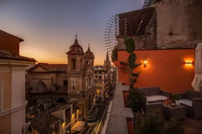 a view of a city at sunset from a balcony at Tritone Top House in Rome