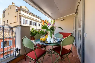 a patio with a table and chairs on a balcony at Incentrum in Rome