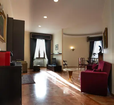 a living room with a red couch and a table at Le Cupoline in Rome