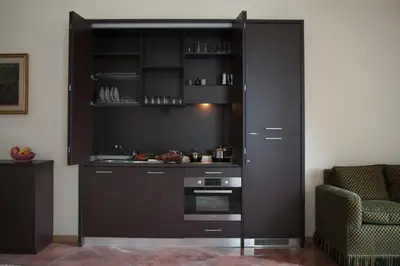 a kitchen with black cabinets and a stove at Le Cupoline in Rome