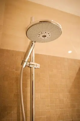 a shower with a shower head in a bathroom at Le Cupoline in Rome