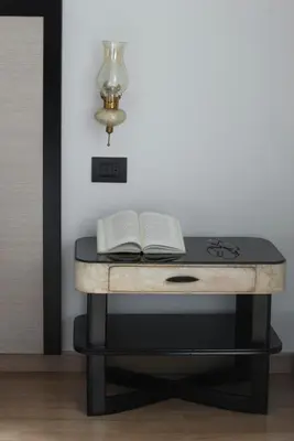 a desk with a lamp and two books on it at Le Cupoline in Rome