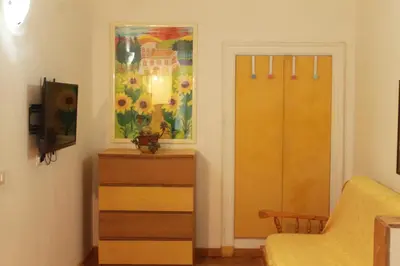 a room with a dresser and a painting on the wall at Daffodil in Roma San Pietro in Rome