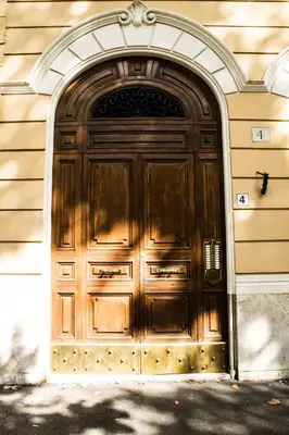 a large wooden door on the side of a building at Daffodil in Roma San Pietro in Rome