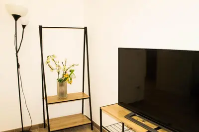 a flat screen tv sitting next to a mirror at Daffodil in Roma San Pietro in Rome