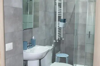 a bathroom with a sink and a glass shower at Daffodil in Roma San Pietro in Rome