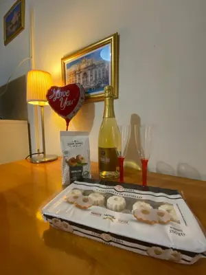 a table with a bottle of wine and a tray of donuts at Amazing Vaticano in Rome
