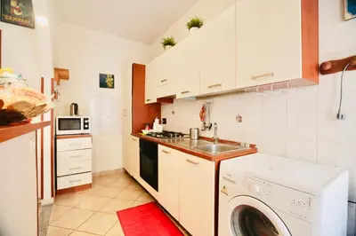 a kitchen with a washing machine and a sink at Amazing Vaticano in Rome
