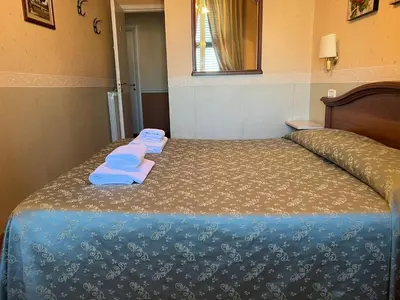 a bedroom with a bed with towels on it at B&B San Michele a Porta Pia in Rome