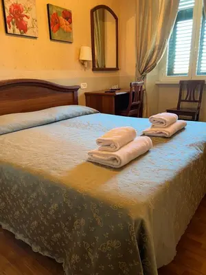 a bedroom with a bed with two towels on it at B&B San Michele a Porta Pia in Rome