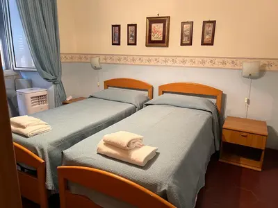 two beds in a hotel room with towels on them at B&B San Michele a Porta Pia in Rome