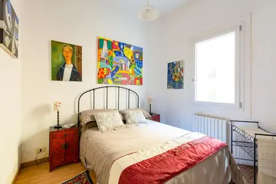 a bedroom with a bed and some paintings on the wall at Savelli Apartment in Rome