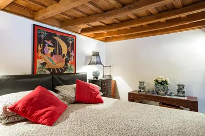 a bedroom with a bed with red pillows on it at Savelli Apartment in Rome