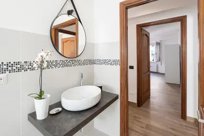 a bathroom with a white sink and a mirror at G&C house in Rome