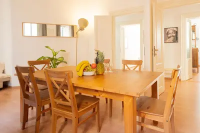 a dining room with a wooden table with fruit on it at Snooze Trastevere House in Rome
