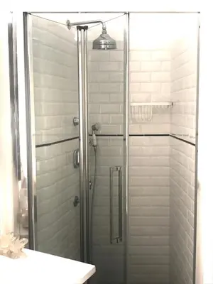 a shower with a glass door in a bathroom at Snooze Trastevere House in Rome