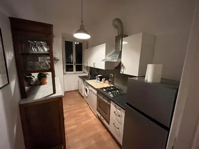 a kitchen with a stove and a refrigerator at Snooze Trastevere House in Rome