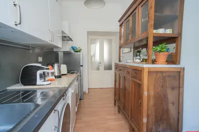 a kitchen with wooden cabinets and a counter top at Snooze Trastevere House in Rome