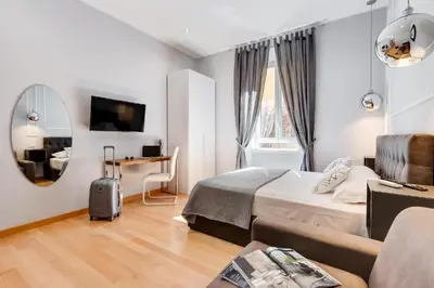 a hotel room with a bed and a table and a mirror at Vatican Prestige Apt by Premium Suites Collection in Rome