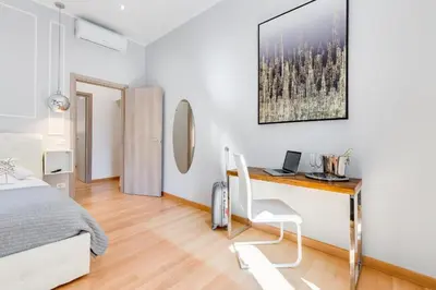 a bedroom with a bed and a desk with a laptop at Vatican Prestige Apt by Premium Suites Collection in Rome