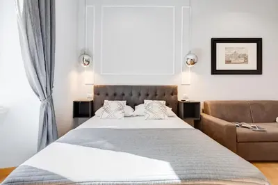a bedroom with a large bed and a couch at Vatican Prestige Apt by Premium Suites Collection in Rome
